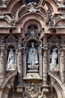 Ornate baroque façade with several statues and decorations, reliefs on the Basilica of St. Francis