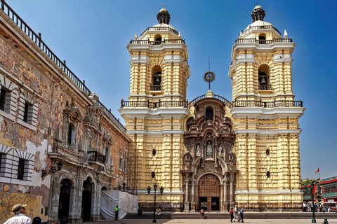 Baroque church with yellow façade and two towers in a sunny atmosphere, The Basilica of St. Francis