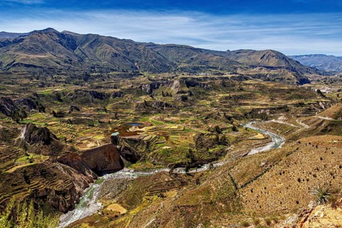 Extensive landscape with terraces and a river in mountainous surroundings, The landscape of the