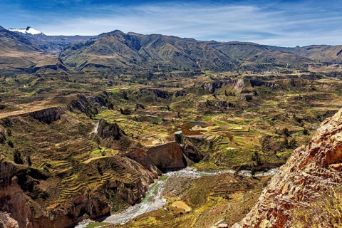 Landscape with terraces, mountains and a river under a blue sky, The landscape of the Colca Canyon