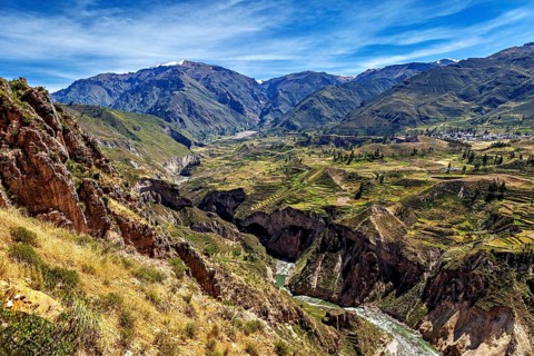 Deep gorge with river and terraced fields in the mountains, The landscape of the Colca Canyon in