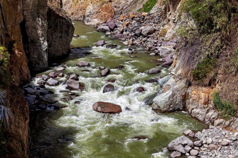 River with fast rapids flanked by rocks, The landscape of the Colca Canyon in the Andes of Peru