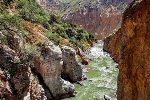 Natural canyon with a green river between rocks, The landscape of the Colca Canyon in the Andes of
