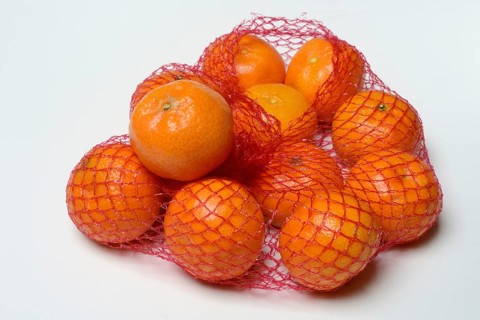 Clementines in a net, tropical fruit