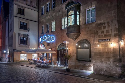 Historic restaurant, Alte Küch'n, with choirs in the evening lighting in the old town,