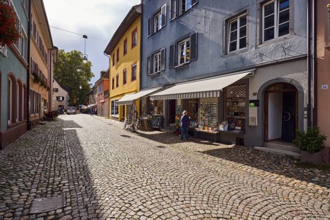 Historic residential and commercial buildings, houses, façade with windows, shutters, awnings and