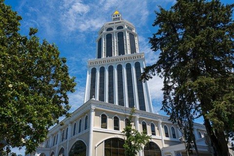An imposing tower rises among trees under a clear blue sky, Sheraton Hotel, Batumi, Black Sea,