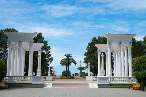 Classic column structure in the park with benches under a blue sky, colonnades, Batumi, Black Sea,