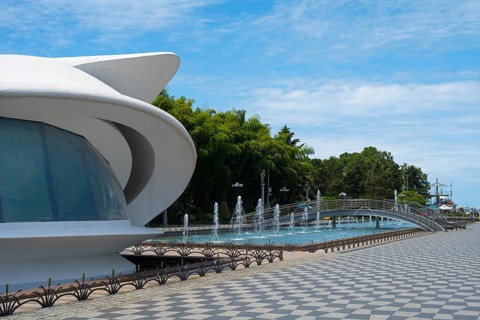 Futuristic building next to a fountain under a blue sky, left registry office, Batumi Boulevard,