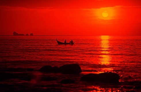 Fishing boat at sunset, silhouettes, orange filter, Ko Lanta island, Thailand, December 2002,