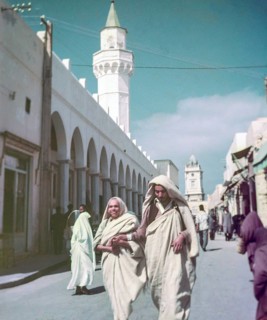 Leading blind person in street, Tripoli, Libya, North Africa 1956 minaret of Ahmed Pasha Karamanli