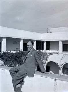 Smartly dressedBritish man sitting on hotel wall of Arabic style building, Tripoli, Libya, North