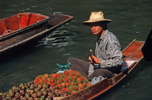 Merchant in his boat at Damnoen Saduak Floating Market, Thailand, December 2002, vintage, retro,