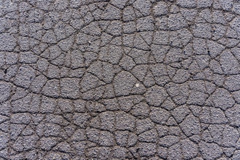 Asphalt surface, floor, with many small cracks, roadway, parking lot
