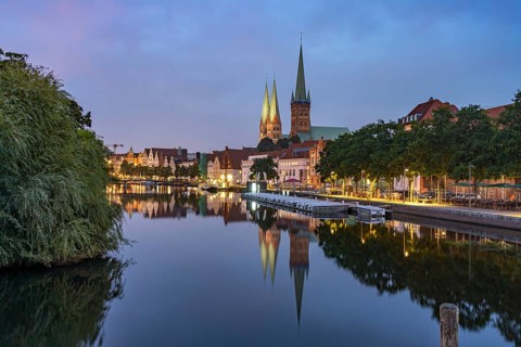 Old town with St. Mary's Church and St. Peter's Church and the Trave at dusk, Lübeck,