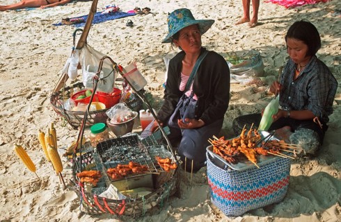 Woman and daughter with food stash on Pranang Cave beach, two years in front of the tsunami, Krabi,