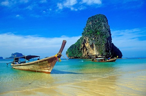Rocks in the sea and longtail boats on Pranang Cave beach, two years in front of the tsunami,