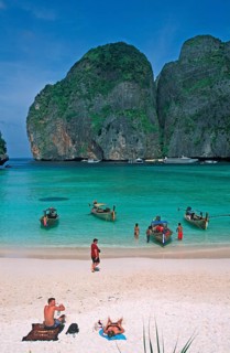 People, longtail boats on Maya Bay beach, known from the movie The Beach, one year in front of the