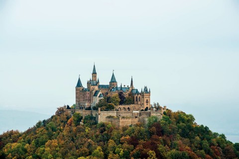 Castle and autumnal forest, Hohenzollern Castle, Hechingen, Swabian Jura, Baden-Württemberg,
