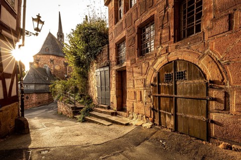 Romantic alleyway scene in the old town with sunlight, shadows and old architecture, The historic