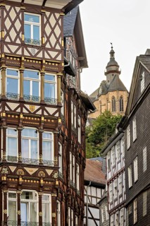 Combination of elaborate half-timbered details and Gothic church tower in the cityscape, The