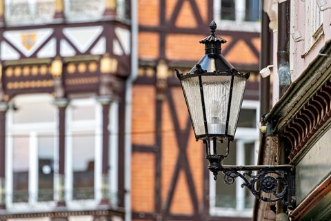 Nostalgic lantern in front of a half-timbered house with traditional architectural elements, The