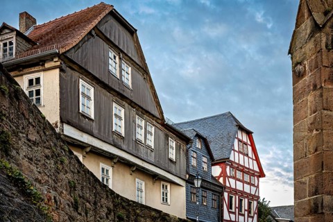 Historic buildings with tiled roofs along a city wall, The historic city center of Marburg in Hesse