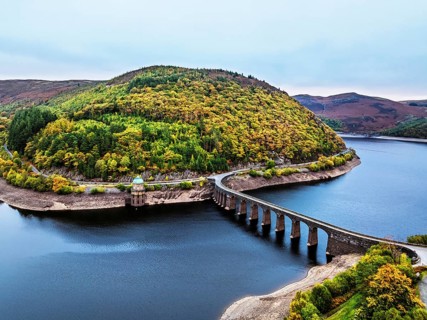 Autumn over Garreg Ddu Dam from a drone, Elan Valley, Caban-Coch Reservoir, Rhayader, Wales, UK