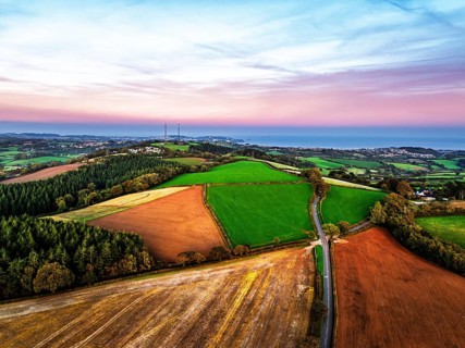 Sunset of Devon Farms and Fields over Berry Pomeroy from a drone, Totnes, England, United Kingdom