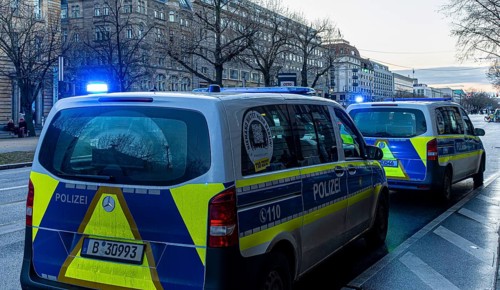 Police vehicles with flashing lights switched on, special operation at the Berlin State Library,