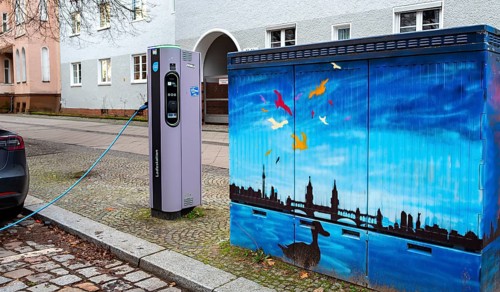 Electric charging station next to a blue-painted distribution box on public roads, Berlin, Germany