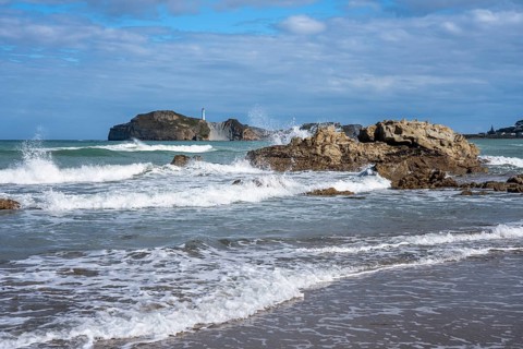 Castlepoint Beach and Castlepoint Lighthouse, ocean, waves, surf, sandy beach, rocks. Castlepoint,