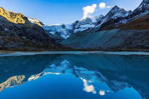 The Moiry glacier and mountain peaks are reflected in Lac de Chateaupre, Val d'Anniviers, Valais