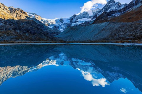 The Moiry glacier and mountain peaks are reflected in Lac de Chateaupre, Val d'Anniviers, Valais