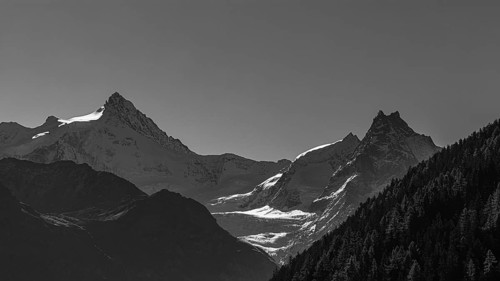 The snow-capped peaks of the Zinalrothorn and Besso mountains, black and white photo, Val