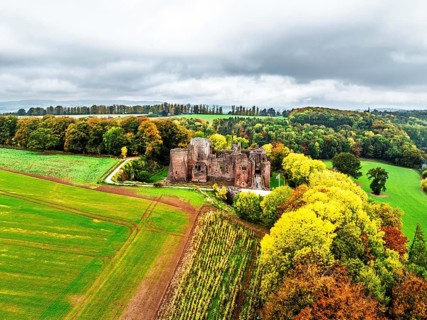 Autumn Colours over ruins of Goodrich Castle and River Wye from a drone, Goodrich, Herefordshire,