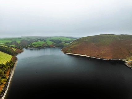 Autumn colours over Llyn Clywedog and Clywedog Reservoir from a drone, Llanidloes, Wales, UK