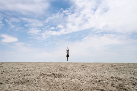 Symbolic picture, abstract, man jumping on the Etosha pan, salt pan, Etosha National Park, Namibia
