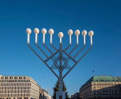 Large Hanukkah chandelier at the Brandenburg Gate in daylight, sign of lively Jewish life, symbolic