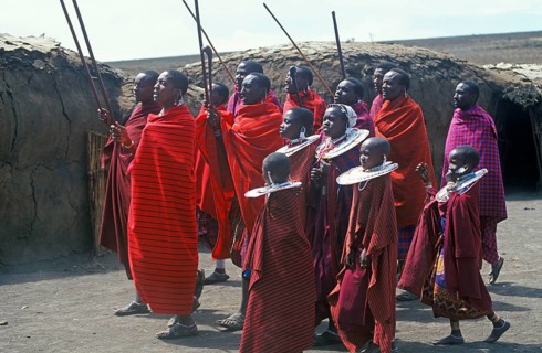 Maasai men and girls in their village in the Ngorongoro Crater dancing for tourists, Tanzania,