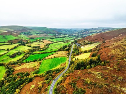 Autumn colours of Farms over River Wye and Road A470 from a drone, Llanidloes, Powys,