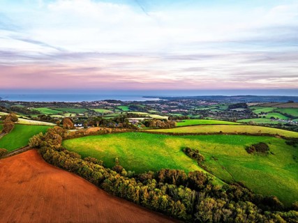 Sunset of Devon Farms and Fields over Berry Pomeroy from a drone, Totnes, England, United Kingdom
