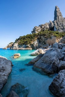 Light blue clear sea on a dream beach on Cala Goloritzé, picturesque rocky coast, steep coast with