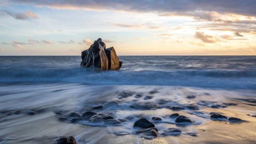 Sunset, waves and rocks in the sea, Praia Formosa, Madeira, Portugal
