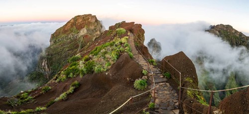 Sunrise at Pico do Arieiro, clouds of fog sweep over mountain peaks, sea of fog, hiking trail PR1,