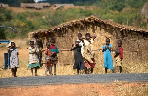 Children in front of a straw hut on the side of the road, Bwangu Mzimba, Malawi, Africa, June 2000,