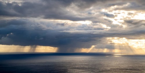 Sunset, sun rays over sea, dark rain cloud, rain, Madeira, Portugal