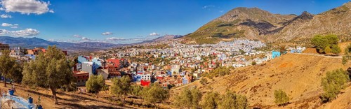 Colourful houses on a mountainside under a clear blue sky, Morocco, Chefchaouen, panorama