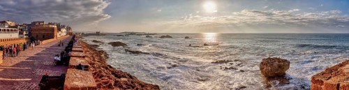 Dramatic coastline with strong waves and setting sun, Morocco, Essaouira, panorama