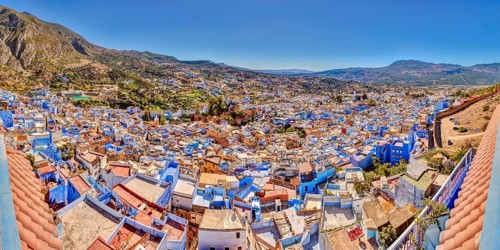 View of a city full of blue buildings with mountains in the background, Morocco, Chefchaouen,